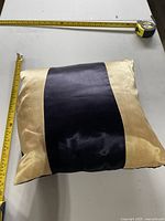 Pillow placed on table with measuring tapes showing size