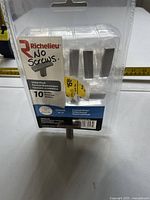 Front of sealed Richelieu value pack showing 10 brushed nickel drawer pulls and note indicating no screws
