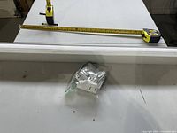 Headrail of blind with tape measure and hardware bag