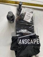 All four items: sealed toiletry bag, boxer briefs, two grooming bottles