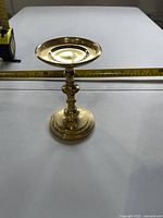 Overall view showing full candle pedestal with tape measure for scale