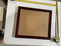 Overall view of rectangular wooden frame with measuring tapes showing dimensions