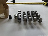 All lug nuts, locking nuts, key and box displayed on table