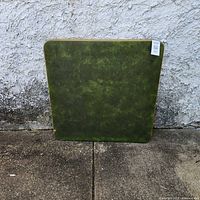 front view of green vinyl card table showing surface and overall condition