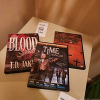 All three DVD cases on table showing front covers