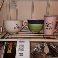 Front view of all three mugs on shelf