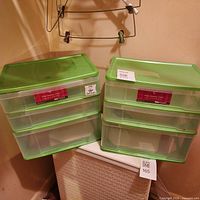 Both green-topped clear plastic drawer organizers side by side