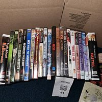 Row of roughly 22 DVD cases showing titles such as Twins and Get Smart