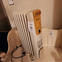 Front view of oil-filled radiator heater showing control panel and brand