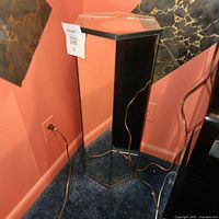 Full view of mirrored glass pedestal stand