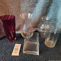 Group shot of five glass vases on carpet