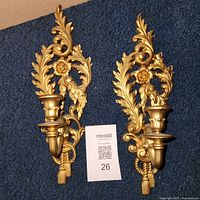 Both gold-tone wall sconces front view