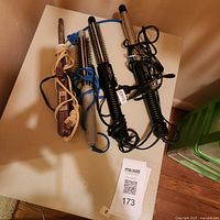 Entire group of five curling irons on table