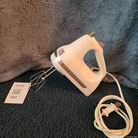 Full view of KitchenAid hand mixer with cord and beaters