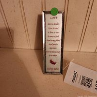 Front view of glass plaque showing full poem text and frame