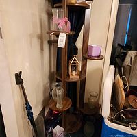 Full view of wooden stand in corner showing shelves and base