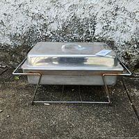 Full view of chafing dish on stand with lid