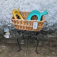 Full view of metal side table with basket and plate holders