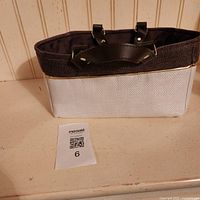 Front view of tote bag showing two-tone exterior and handles