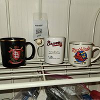 All three mugs on shelf: St. Louis Cardinals, Atlanta Braves, Louisville Redbirds