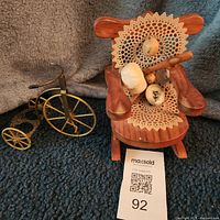 Full view of miniature rocking chair with sports items and penny-farthing bicycle