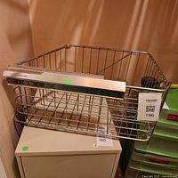 Overall view of metal wire freezer basket on small cabinet