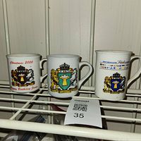 All three TBN mugs on shelf