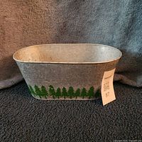 Front angled view showing pine tree motif