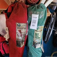 Red and green Ozark Trail folding chairs in carry bags