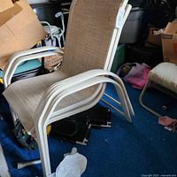 Full view of one chair showing frame, armrests, sling seat and back