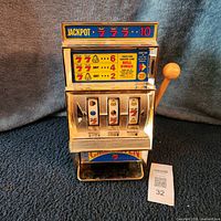 Front view showing jackpot graphics, reels, payout tray, lever, overall condition