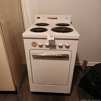 Full view of white Westinghouse electric stove with four burners and oven door