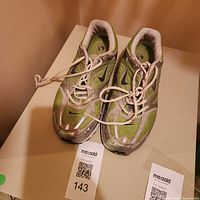 Top view of both sneakers showing overall style, color, laces, interior