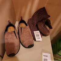 Pair of Merrell slip-on shoes and pair of LL Bean knit slipper socks on shelf