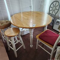 Table fully extended with stools and chair around it