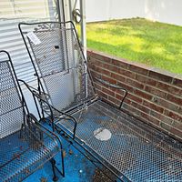 Full view of wrought iron chaise lounge on patio