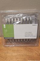 Front view of unopened clamshell showing nine satin nickel cabinet pulls and label indicating 10 pack, 3.78 in, Style Selections