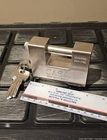 Casa hardened steel padlock with keys next to ruler