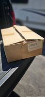 Closed cardboard shipping box showing label 710971