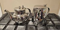 Both chrome pots side by side showing size and finish