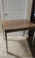 Full view of kitchen table front angle showing top and legs