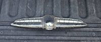 Front view of chrome winged hood ornament
