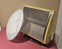 Heater angled view with glass shade leaning against it
