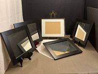 Group of four mirrors and one diploma frame displayed on stands