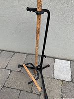 Full view of guitar stand with rulers showing dimensions