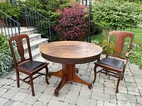 Table and two chairs on patio, full view