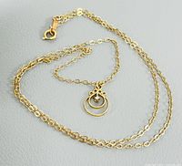 Full view of yellow gold chain with pendant and clasp