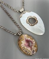 Both sterling silver necklaces with their pendants displayed
