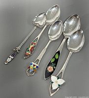 All five sterling enamel souvenir spoons displayed
