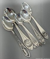 Front view of all five spoons showing handle designs